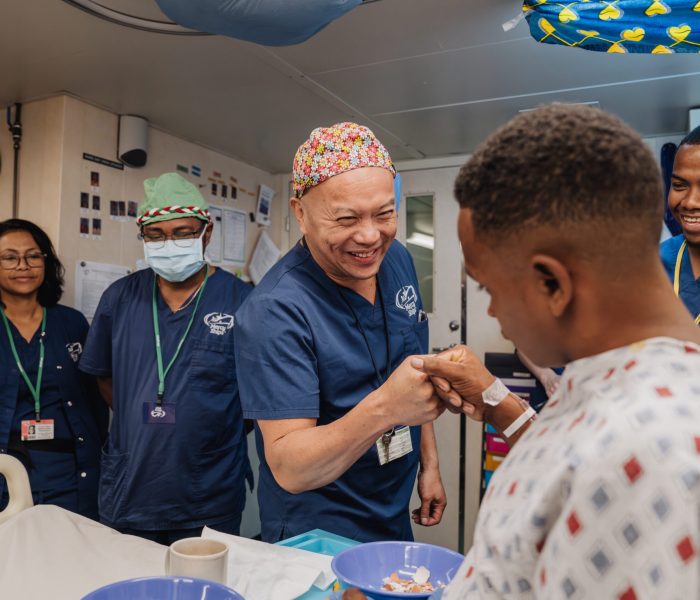 Dr. David Chong, Maxillofacial Head and Neck Surgeon, with Romain Raherison, ETA Surgeon, during morning rounds with Joseph, cleft lip patient.