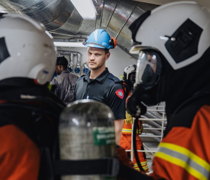 Lars Eirik, Firefighter, observing the fire teams during a fire drill.