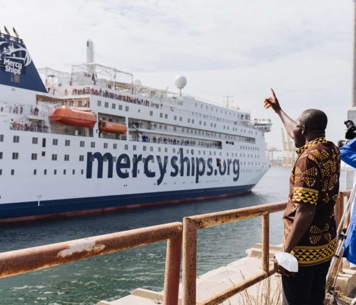 Volunteer Crew and Day Crew wave as the Global Mercy enters the Port in Dakar.