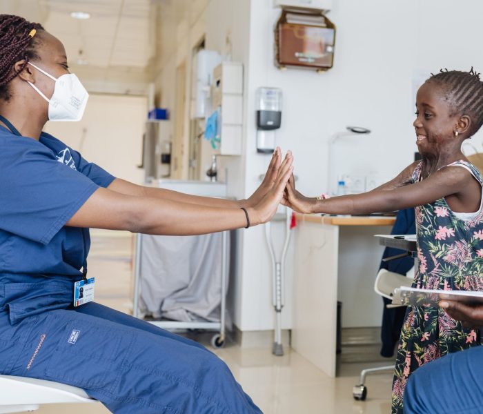 Satou, plastics patient, at rehab before surgery with Becky Chaplin, Hand Therapist.